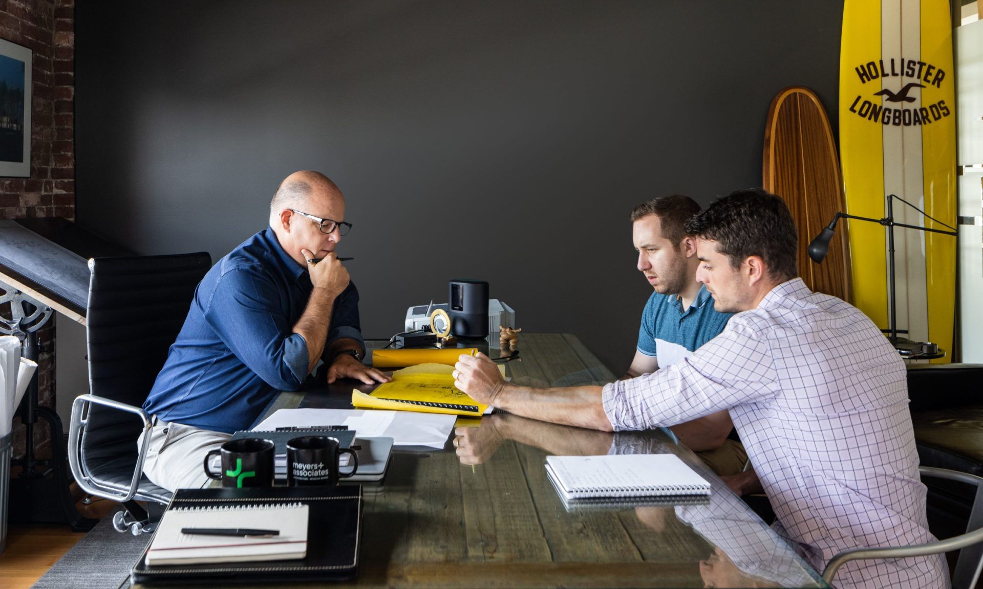 Chris Meyers, FAIA, with Brian Peterson, AIA and ay Schwartz, AIA reviewing a project